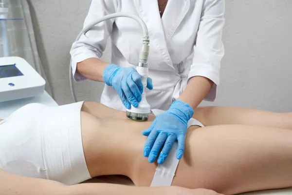 Lost the Weight but Not the Loose Skin? 2 woman having HIFU treatment on her stomach to combat loose skin Stony Stratford following weight loss